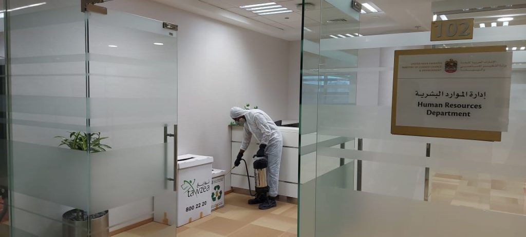 Pest control technician servicing an office space in Dubai